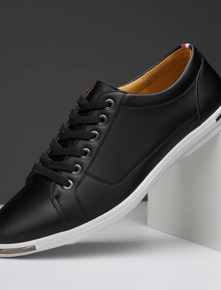 Black leather low-top sneaker with lace-up front and white rubber sole