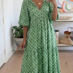 Green patterned maxi dress with V-neck and gathered skirt; front view