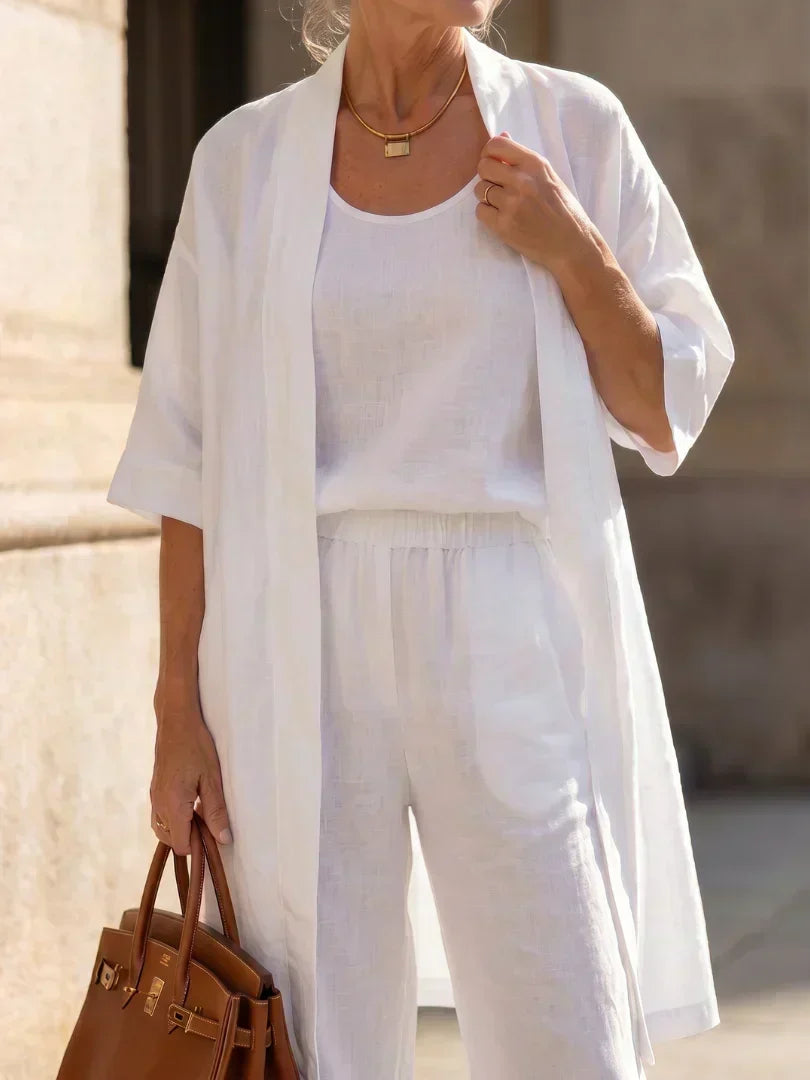 3-piece white set close-up: long tunic over square-neck top with drawstring-waist pants.
