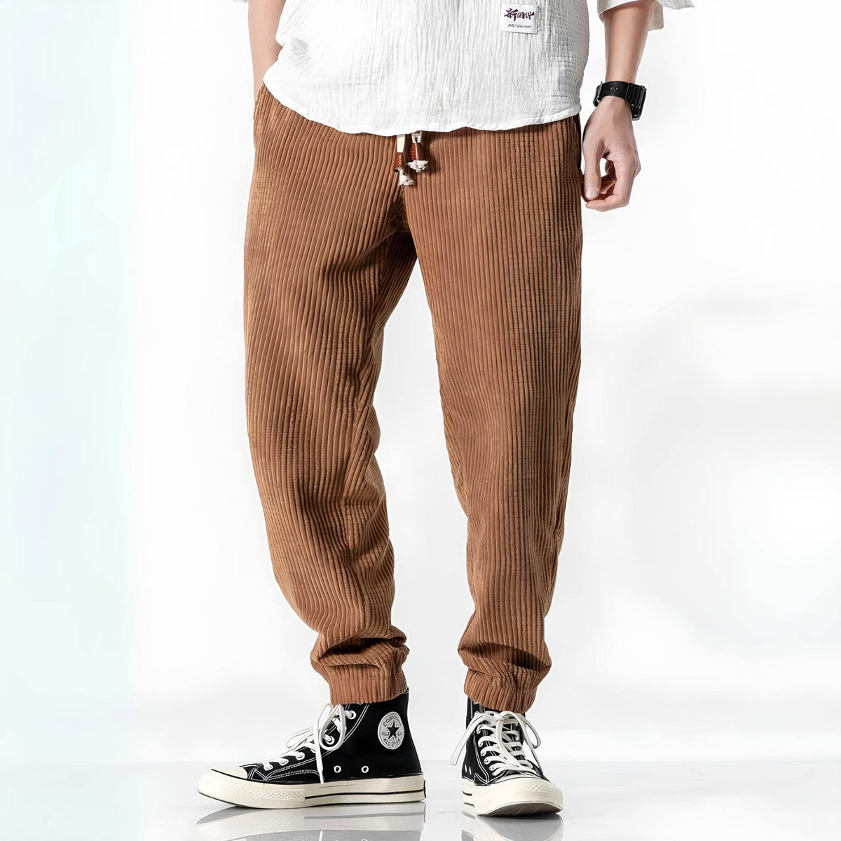 Camel ribbed velvet trousers with tapered legs, elastic cuffs, and drawstring waist