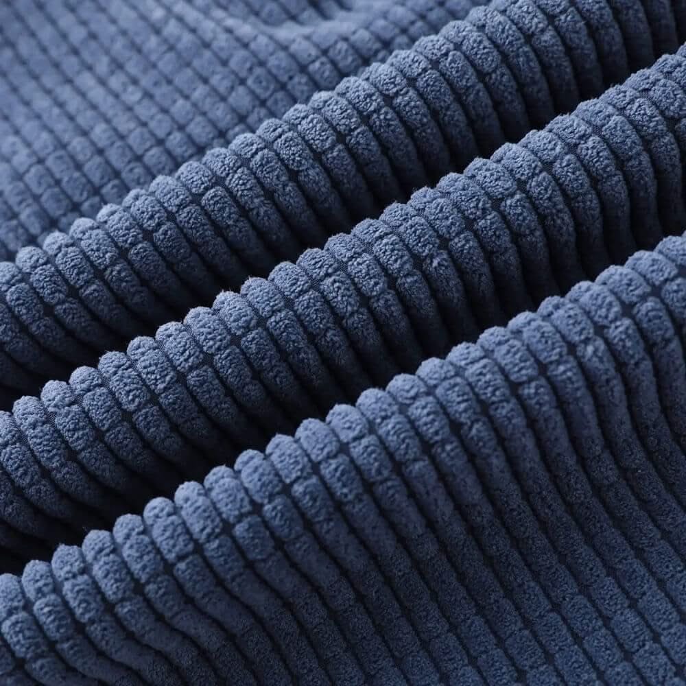 Close-up of blue ribbed velvet fabric texture with raised corded stripes