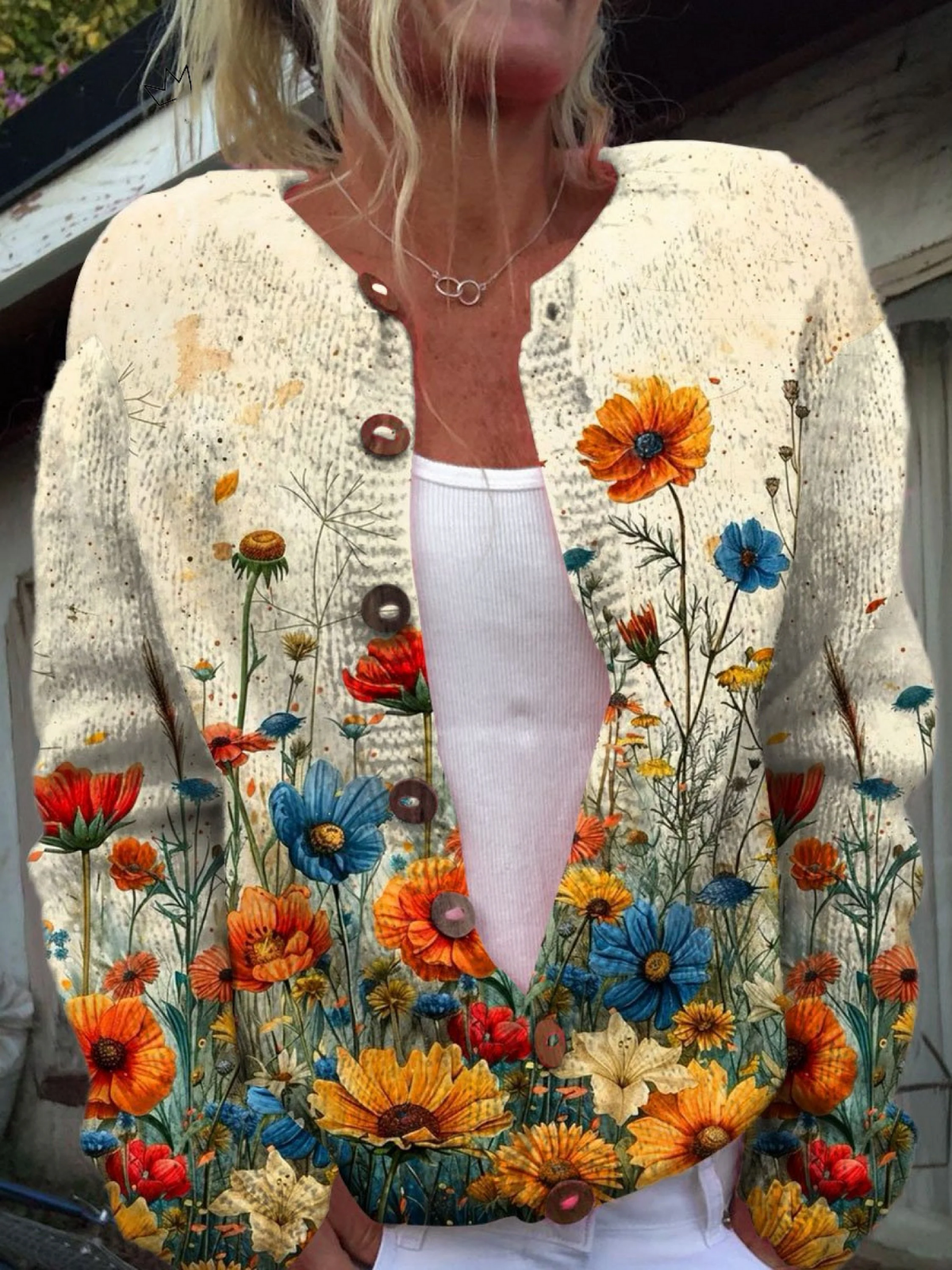 Women’s vintage knit cardigan sweater in cream with colorful floral print and brown buttons