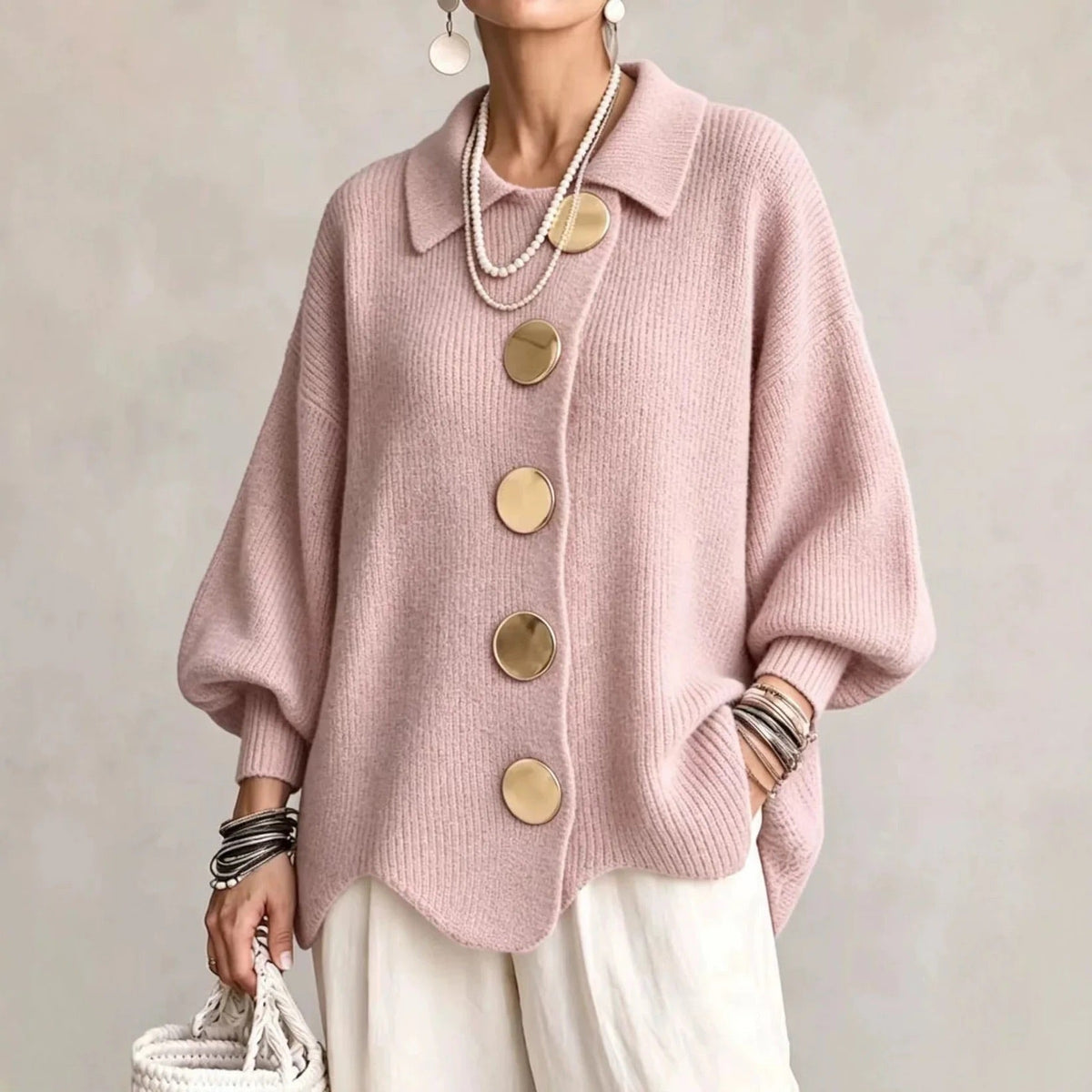 Oversized pink collared button cardigan with long balloon sleeves and large round buttons
