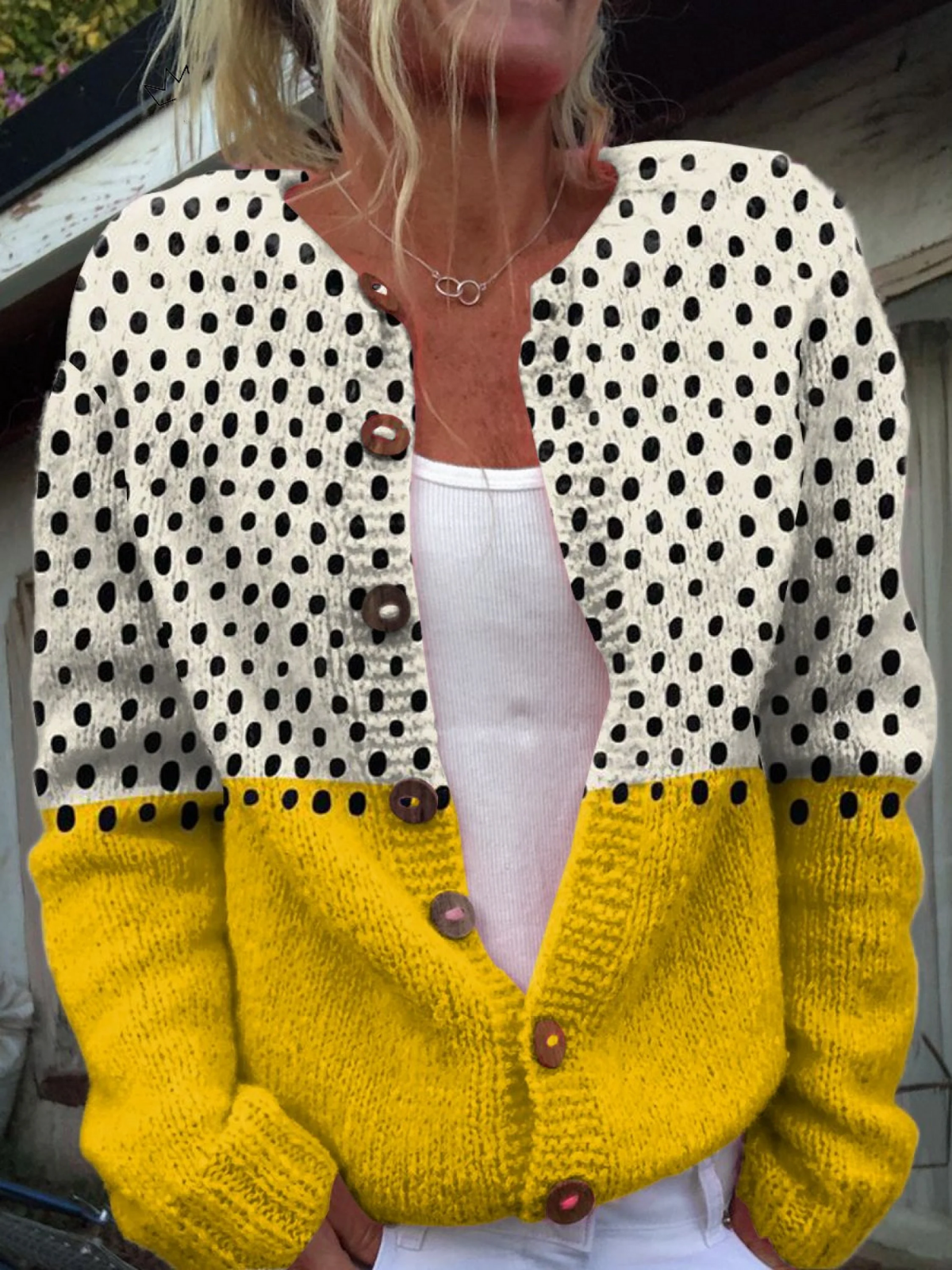 Yellow polka dot buttoned cardigan with long sleeves and yellow ribbed cuffs and hem