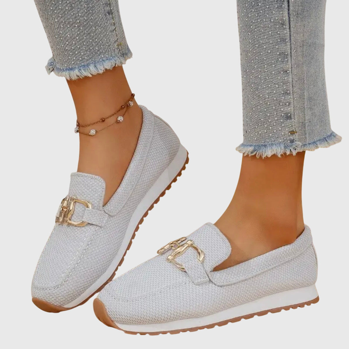 White orthopedic loafer sneakers with gold-tone buckle ornament and treaded sole