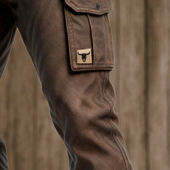 Dark brown utility pants close-up of cargo pocket patch and flap