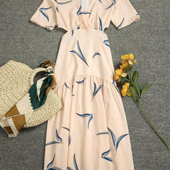 Apricot printed dress with V-neck, short sleeves, gathered waist and tiered skirt