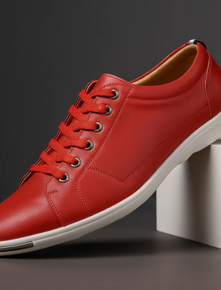 Red leather low-top sneaker with lace-up front and white rubber sole