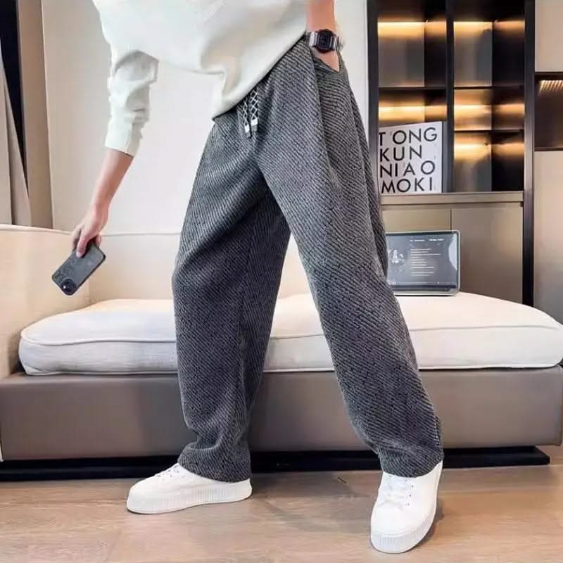 Dark grey textured tapered pants with elastic waistband and drawstring ties