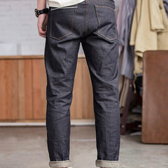 Indigo raw denim jeans with back yoke, front slash pockets, and cuffed hems