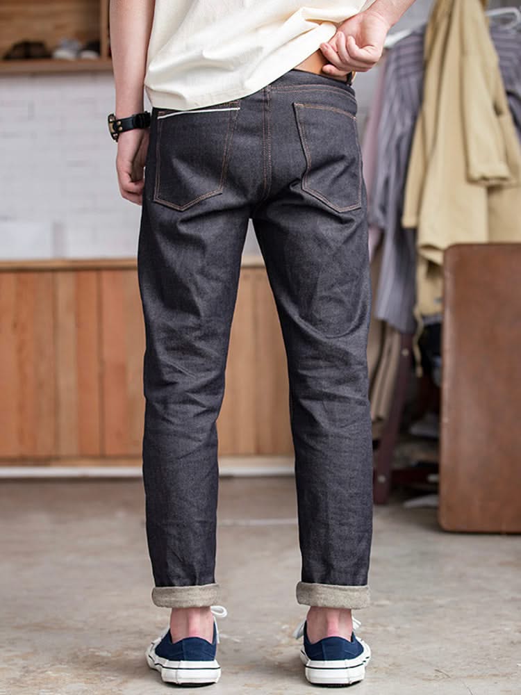 Indigo raw denim jeans with back yoke, front slash pockets, and cuffed hems
