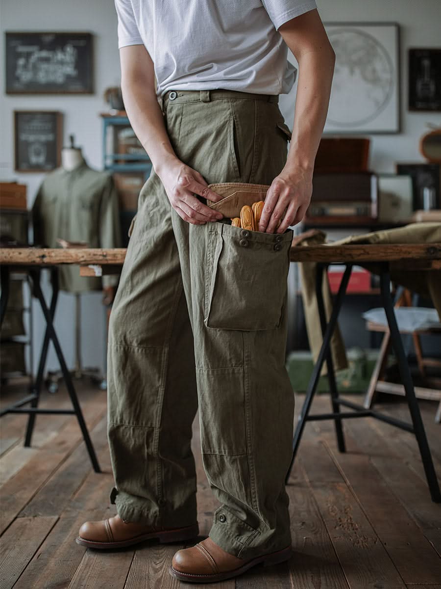Army green cargo trousers with flap pockets and utility pocket opening at hip