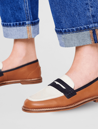 Brown loafers with white strap and black top panel, low-profile tan sole