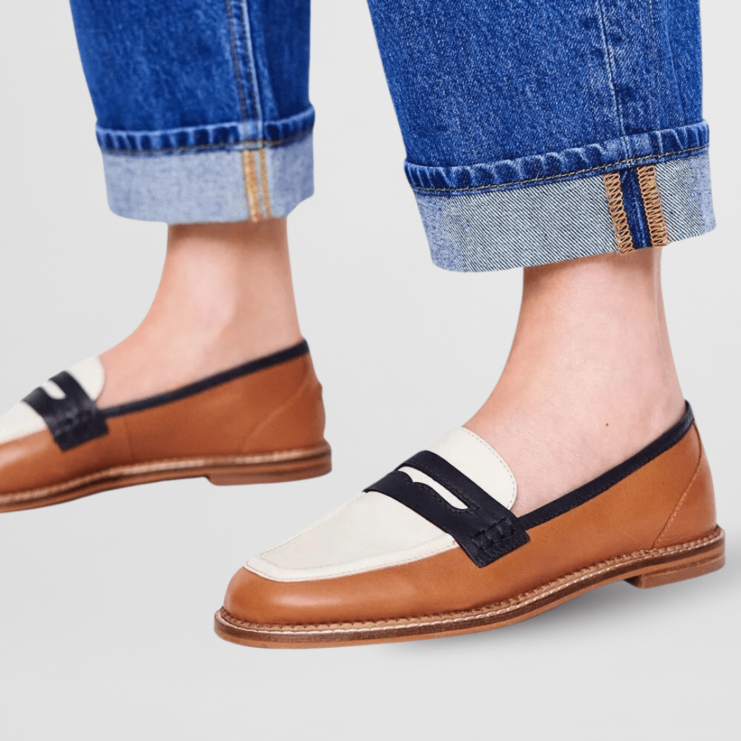Brown loafers with white strap and black top panel, low-profile tan sole