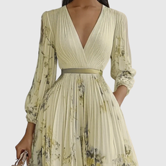 Lime-green pleated maxi dress with V-neck wrap bodice and floral print, long sleeves.