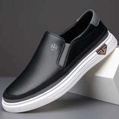 Black slip-on shoes with textured leather upper and striped white rubber sole