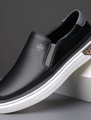 Black slip-on shoes with textured leather upper and striped white rubber sole