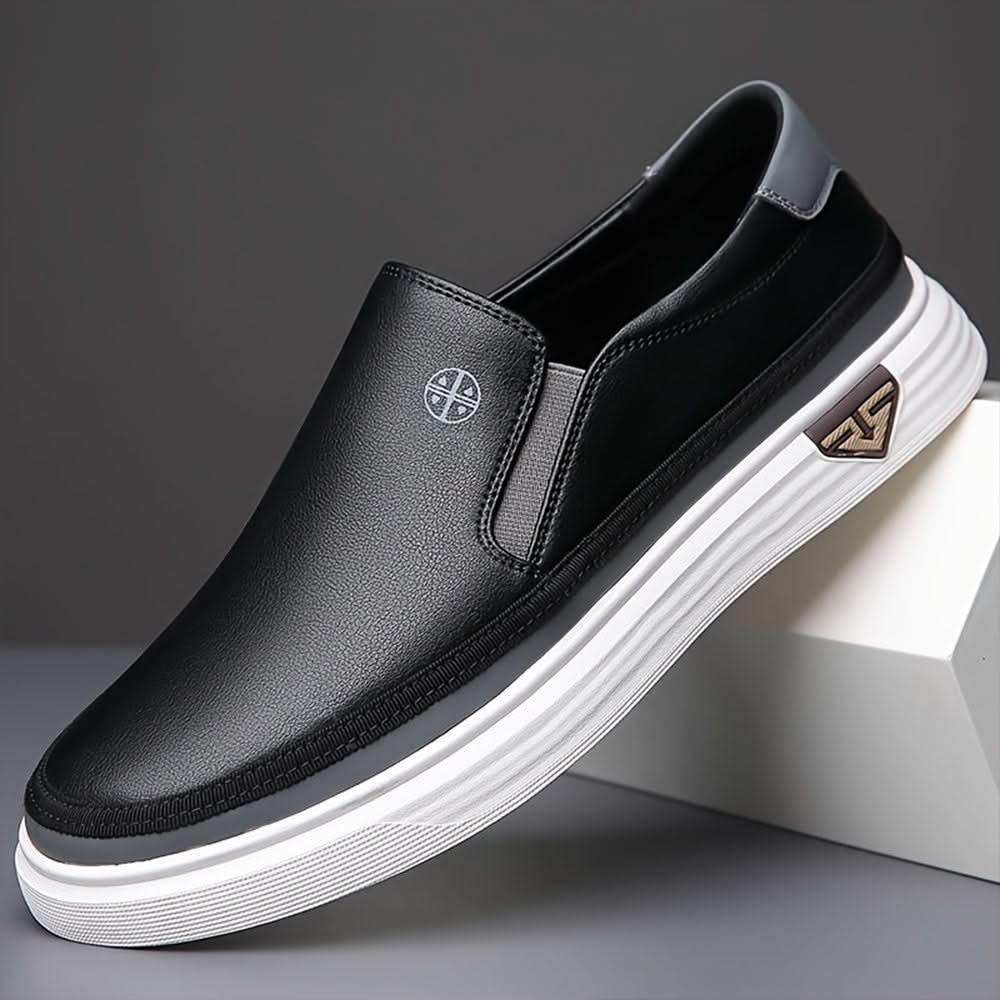 Black slip-on shoes with textured leather upper and striped white rubber sole