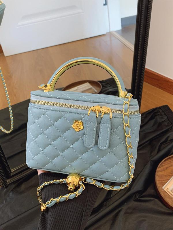 Light blue quilted crossbody bag with gold-tone chain and top zip closure