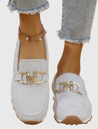 White orthopedic loafer sneakers with gold-tone buckle detailing and textured slip-on