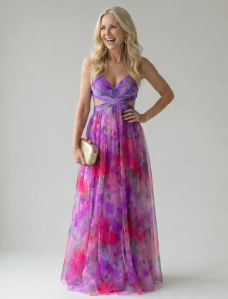 Purple and pink multicolor maxi wrap dress with V-neck, sleeveless bodice, and waist tie.