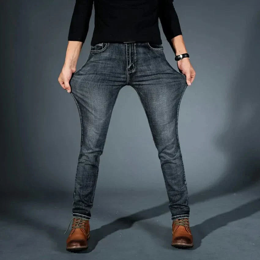 Men's stretch denim jeans, grey-blue slim fit, front seams and tan leather patch