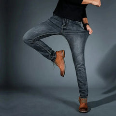Men's stretch denim jeans, medium-blue slim fit, side view with tan leather patch detail