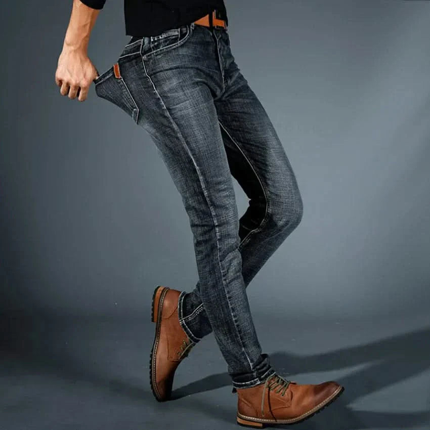 Men's stretch denim jeans, dark blue slim fit, front pocket and stitching visible