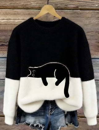 Black oversized sweater with white hem and cuffs, featuring a black penguin front graphic.