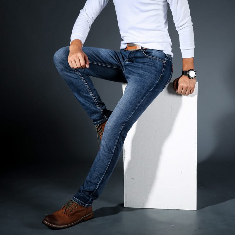 Men's stretch denim jeans, dark blue wash, slim fit with tan leather patch
