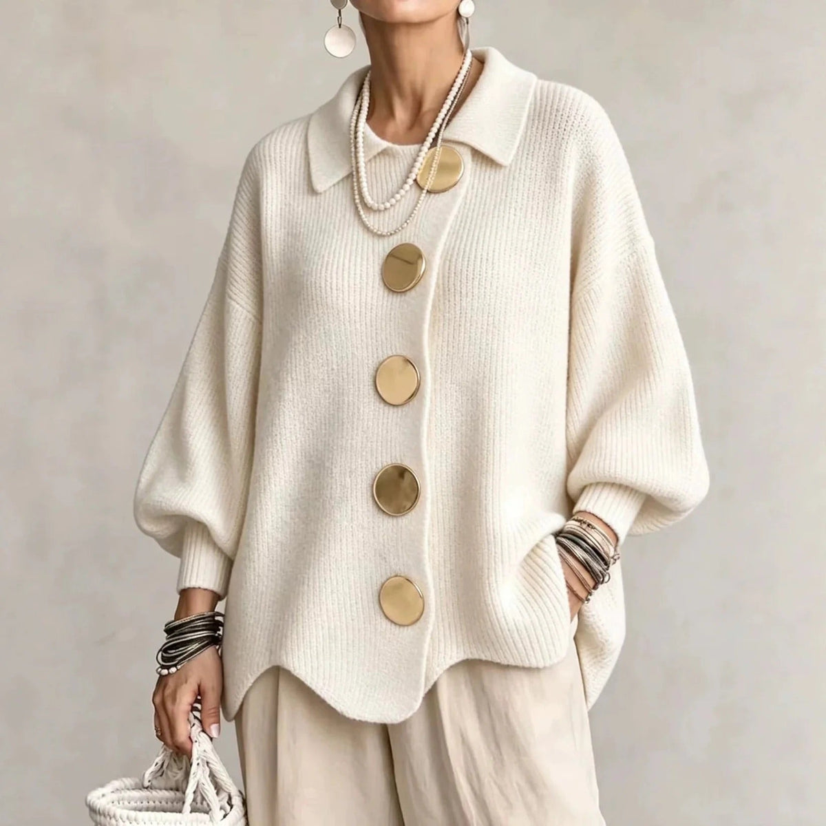 Oversized cream collared button cardigan with long balloon sleeves and large round buttons