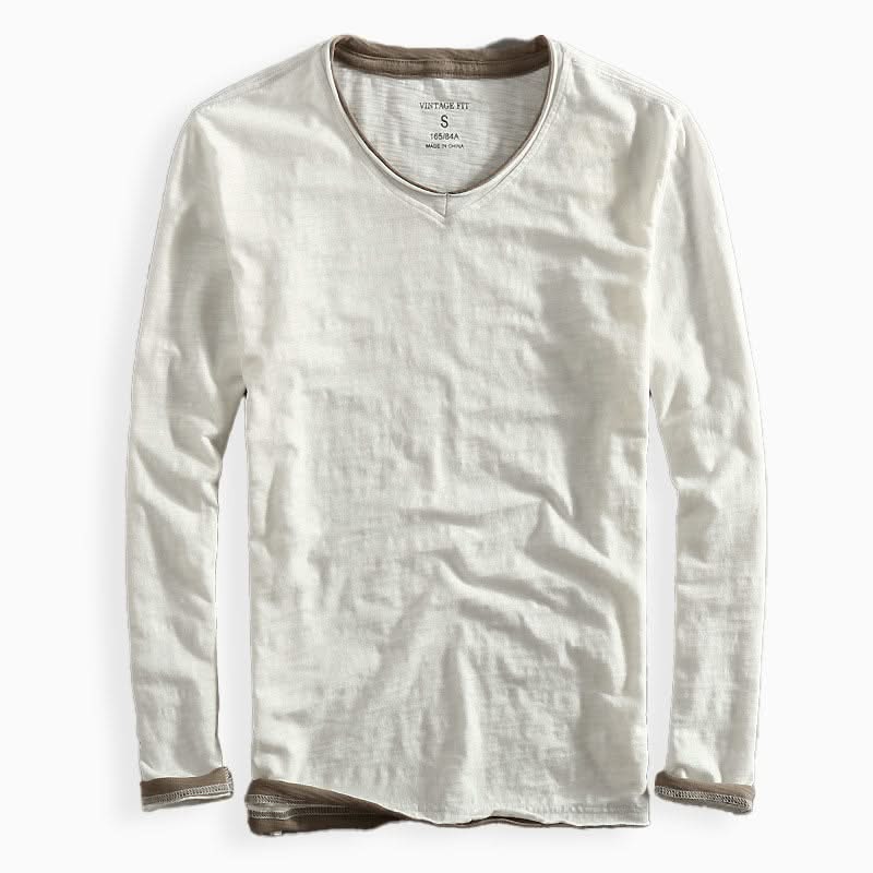 White cotton shirt with V-neck and long sleeves, ribbed cuffs