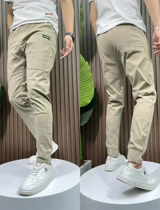 Beige stretch utility pants with cargo pockets and elastic cuffed ankle hem