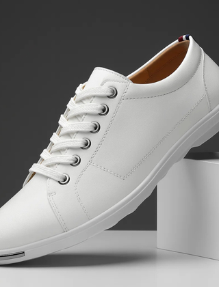 White leather low-top sneaker with lace-up front and white rubber sole