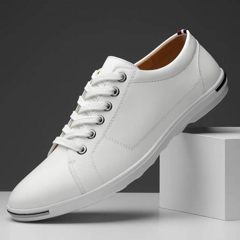 White leather low-top sneaker with lace-up front and white rubber sole