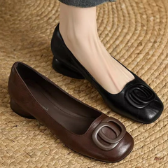 Black and brown leather flats with oval buckle detail and low round toes
