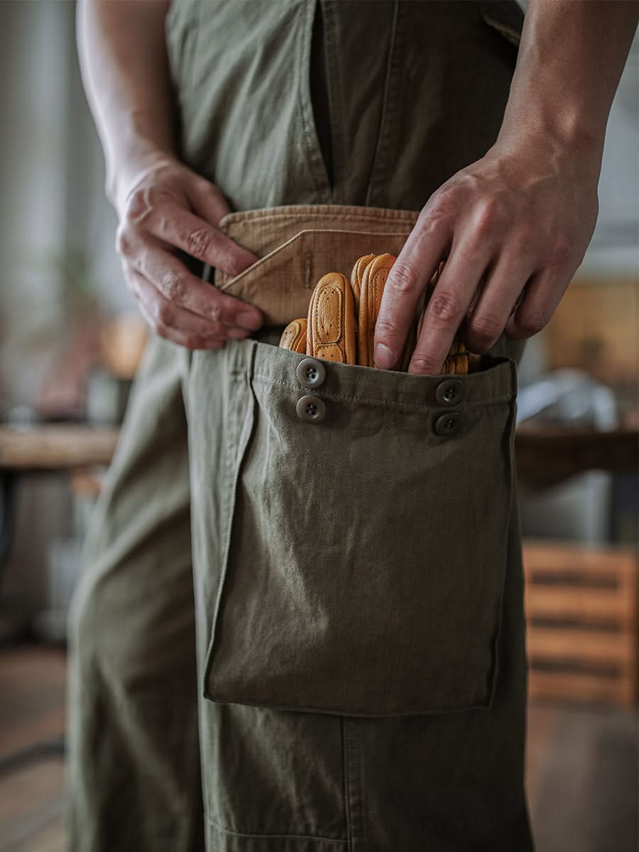 Army green trousers with flap pocket and button closure, visible pocket stitching