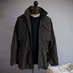 Black heritage utility jacket with hood, snap front, and flap pockets on mannequin