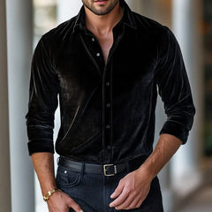 Black velvet button-up shirt with long sleeves and pointed collar.