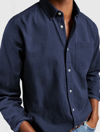 Navy blue denim shirt with long sleeves, button front, and chest pocket