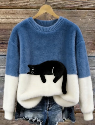 Light blue oversized sweater with white hem and cuffs, featuring a black penguin front graphic.