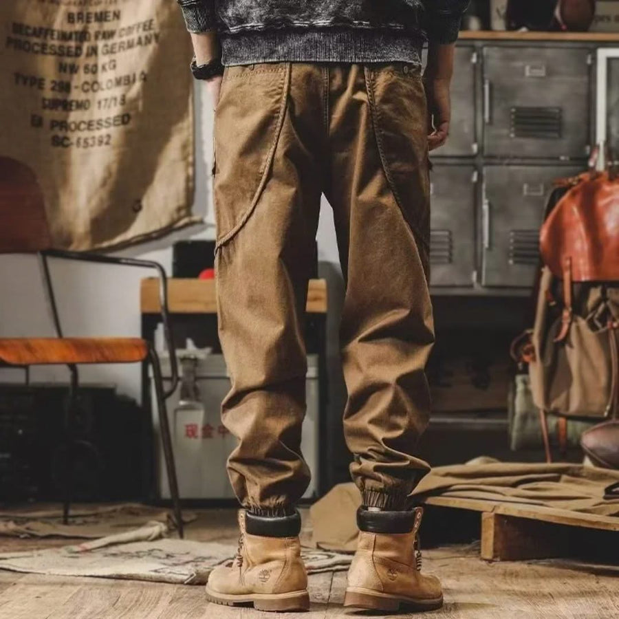 Brown cargo pants with side pockets and drawstring waist, full-length view