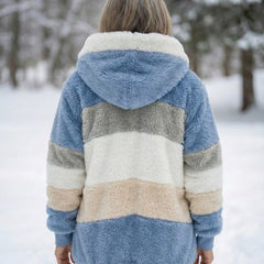 Back view of plush colorblock jacket in blue, cream, and gray with hood
