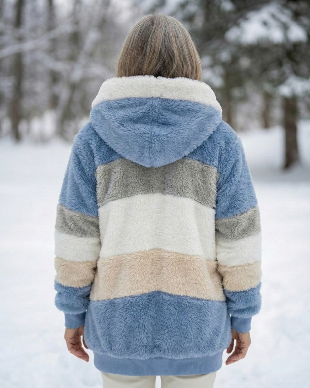 Back view of plush colorblock jacket in blue, cream, and gray with hood