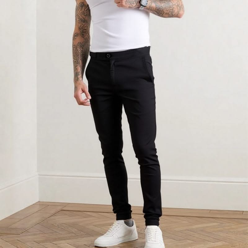 Black slim trousers with belt loops, button closure, and tapered leg