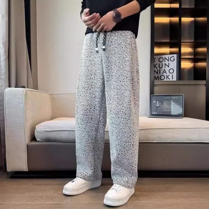 Light grey textured tapered pants with elastic waistband and drawstring ties
