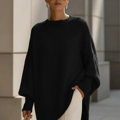 Black drop-shoulder knit jumper with ribbed crew neck and draped asymmetrical hem