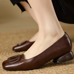 Brown leather ballet flats with oval buckle detail and low heel