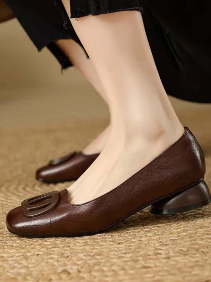 Brown leather ballet flats with oval buckle detail and low heel