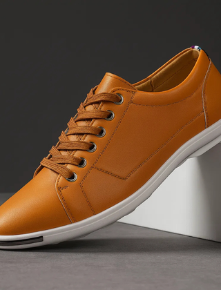 Brown leather low-top sneaker with lace-up front and white rubber sole